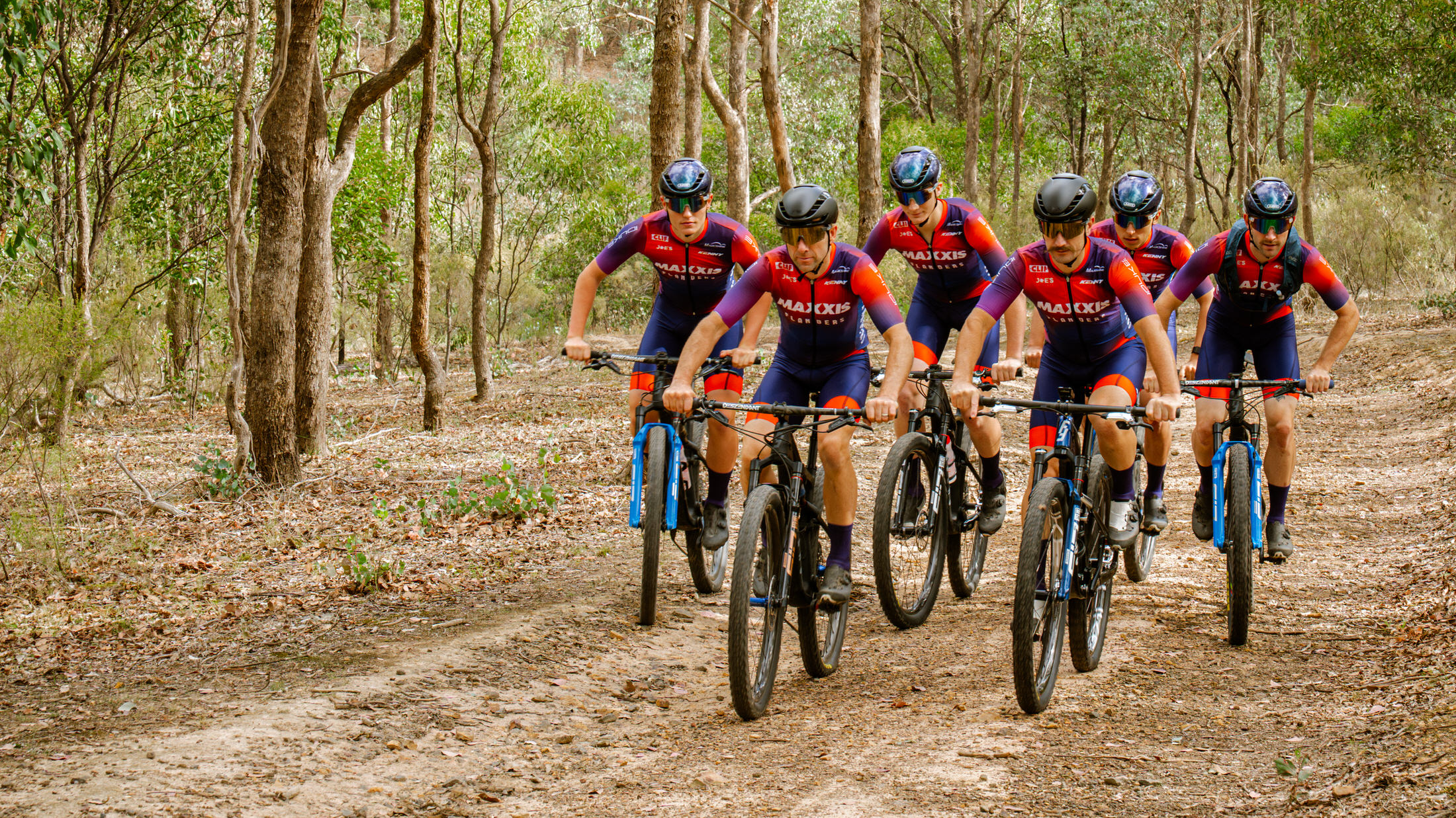 Maxxis Flanders Race Team riders on a forest trail